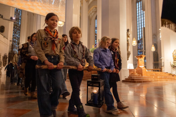 Friedenslicht 2025 - PfadfinderInnen tragen das Friedenslicht durch den Münchner Dom
